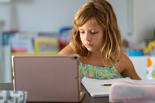 Girl doing her homework with the ipad