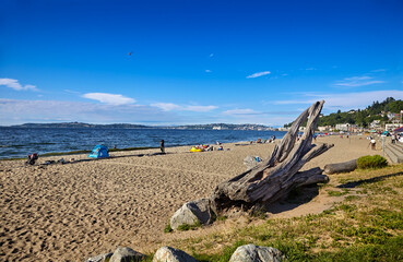 Warm, sunny weather brings people out to Alki Beach, West Seattle, Washington