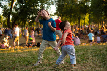 Kids dancing funny, play in a park