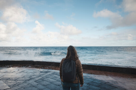 Woman With Backpack Walking At Seafront 