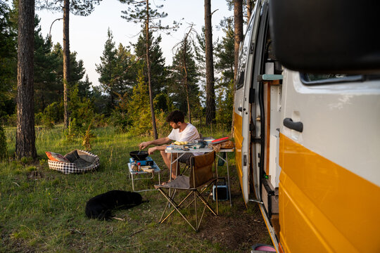 Man camping with camper van in nature