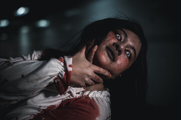 Horror bloodthirsty woman ghost or zombie she is horror scary with breaks her neck at dark night,...