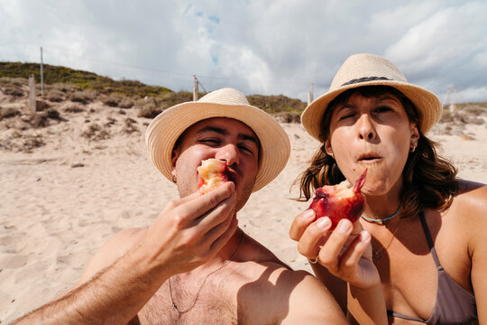 Friends taking a selfie eating fruit