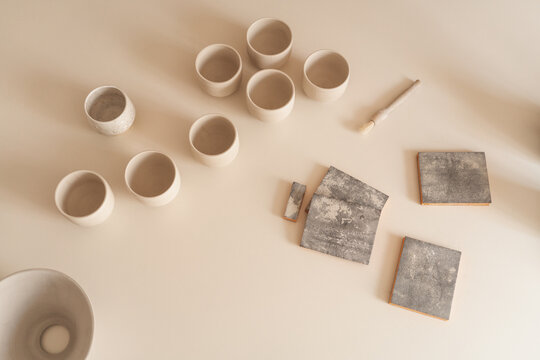 Bisque Fired Pottery And Sandpaper On The White Table 