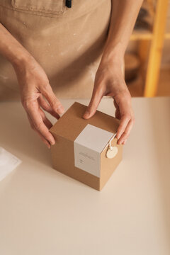Anonymous Woman Packing A Product In A Cardboard Gift Box