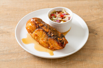 fried snapper fish with fish sauce and spicy salad