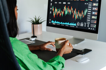 Female trader working on computer in home office