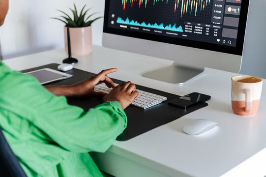 Female trader working on computer in home office