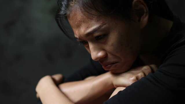 A woman sitting alone and depressed. The depression woman sit on the floor, human trafficking, abuse and people concept