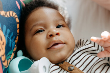 A baby playing with a teething toy