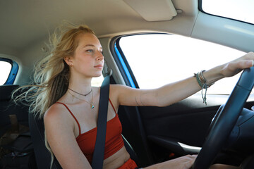 blonde female driving car