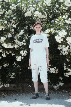 Woman in a summer park on the background of plants