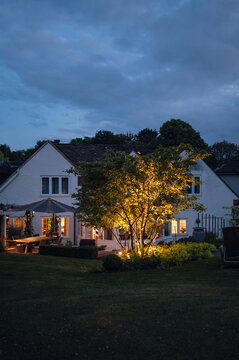 Exterior of a house and its garden at night.