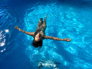 Girl floating in a pool 