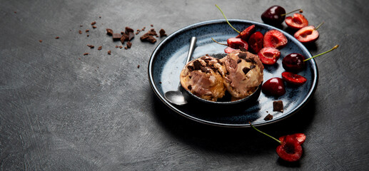 Chocolate ice cream with berries on dark background