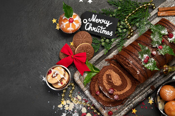 Chocolate yule log on dark background.