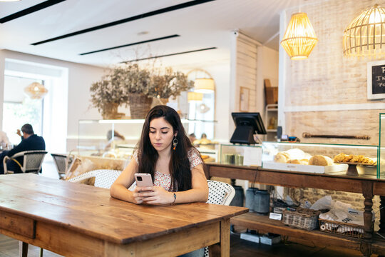 Young woman waiting for her breakfast in a cafe