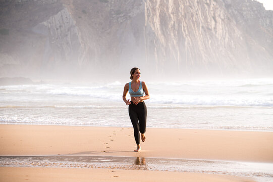 woman running on coast near sea