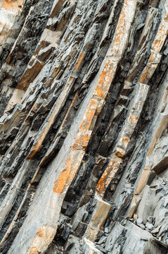 background Rough rocky cliff with uneven surface