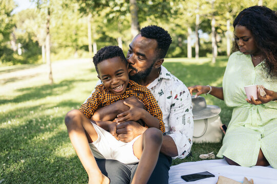 Happy father and son playing on the grass