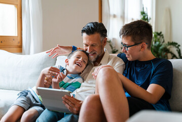 Happy Family Watching Video On Tablet Together