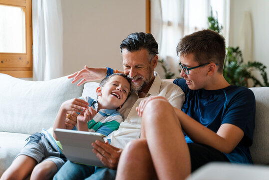 Happy Family Watching Video On Tablet Together