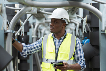 Male plumber engineer worker work with digital tablet in sewer pipes area at construction site....