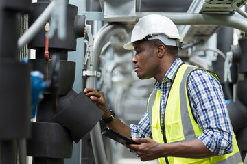 Male plumber engineer worker work with digital tablet in sewer pipes area at construction site....