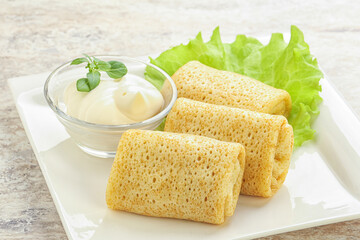 Stuffed pancakes with meat and cream