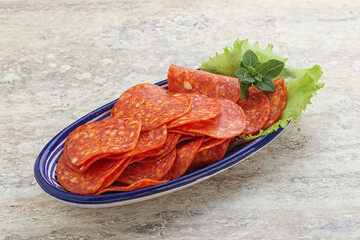 Sliced pepperoni sausage in the bowl