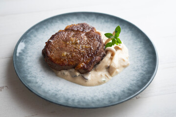 Beef tenderloin with mushroom sauce.