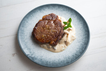 Beef tenderloin with mushroom sauce.