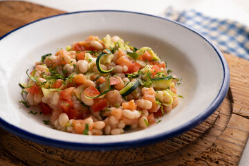 Broad bean salad with zucchini, salmon and tomato.