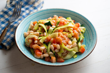 Broad bean salad with zucchini, salmon and tomato.