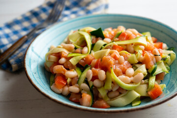 Broad bean salad with zucchini, salmon and tomato.
