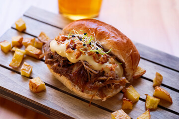 Pulled pork brioche with a beer and crispy onion.