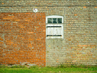 Red brick wall with white windows and doors
