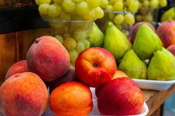 Naklejka na ściany i meble Peachs, figs and other fruits on a street market