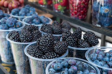 Fresh juicy berries on farmer market, Colorful different fruit sets at street cafe