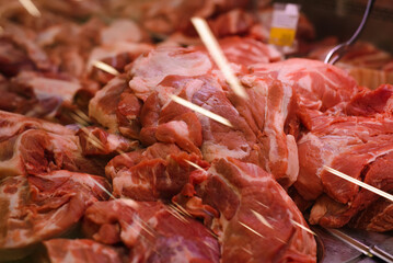 Pieces of raw meat lying on the counter for sale on showcase in a store. Close-up, selective focus