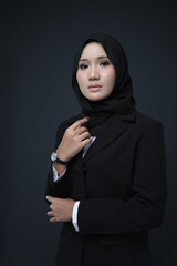 Portrait of a female  wearing a hijab, a form of lifestyle garments for Muslim women, isolated on a background. Eid festive and hijab fashion concept