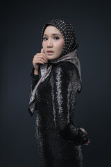 Portrait of a female  wearing a hijab, a form of lifestyle garments for Muslim women, isolated on a background. Eid festive and hijab fashion concept