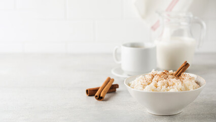  Scandinavian rice porridge in a bowl with cinnamon. Healthy breakfast. Copy space - obrazy, fototapety, plakaty