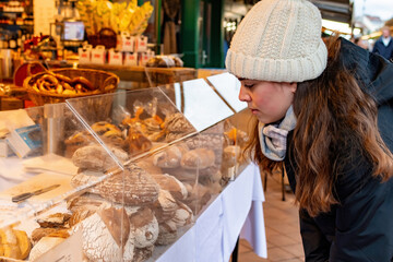 Woman buy bread at the street market stall.