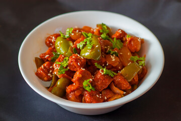 selective focus of Soya Manchurian/Chili Soya bean chunks recipe. with a decorative background.
