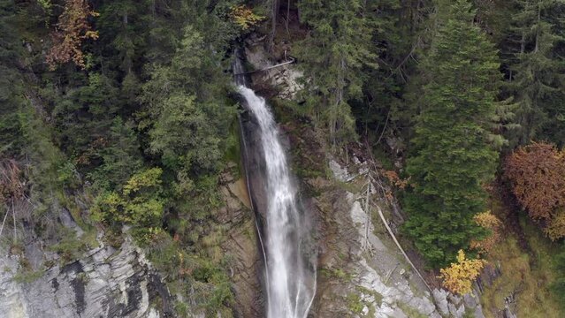 Aerial view of a waterfall surrounded by autumn colors in Lauterbrunnen, Switzerland