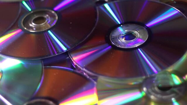 close-up of a many compact discs and other dvds falling dawn