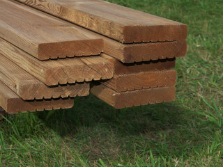 Terrace boards. Stacked boards, close-up photo outdoors with selective soft focus