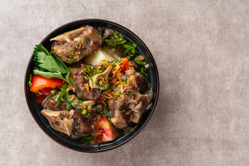 sop buntut or oxtail soup. Made from pieces of beef tail that are seasoned then put in a slightly...