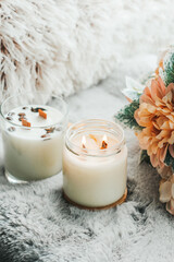 Scented candles in the interior. Interior details in milk colors. Candles in a glass